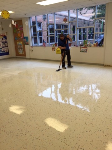 A Gulfside cleaner mopping a school classroom floor